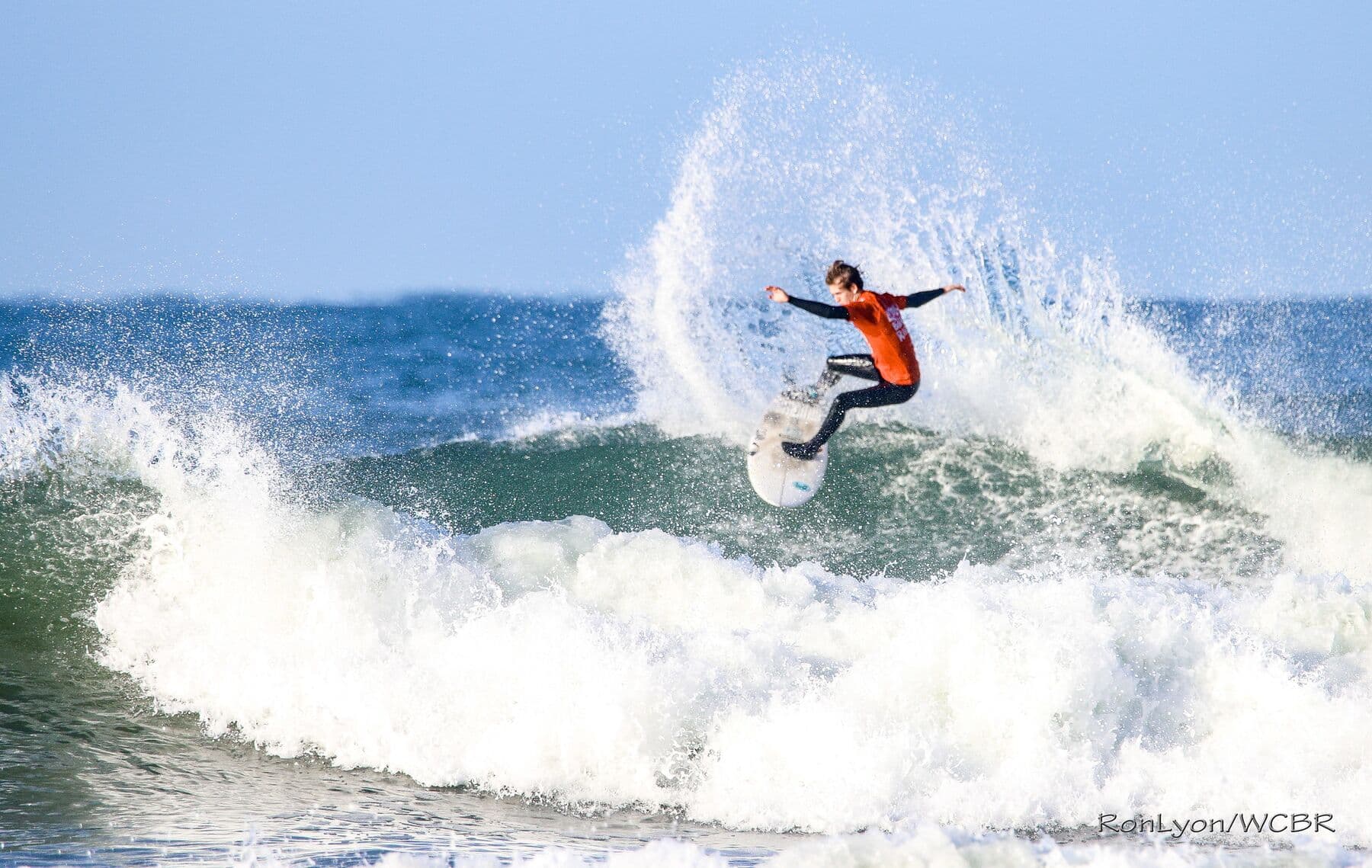 A La Jolla Board Riders surfer launching off a section