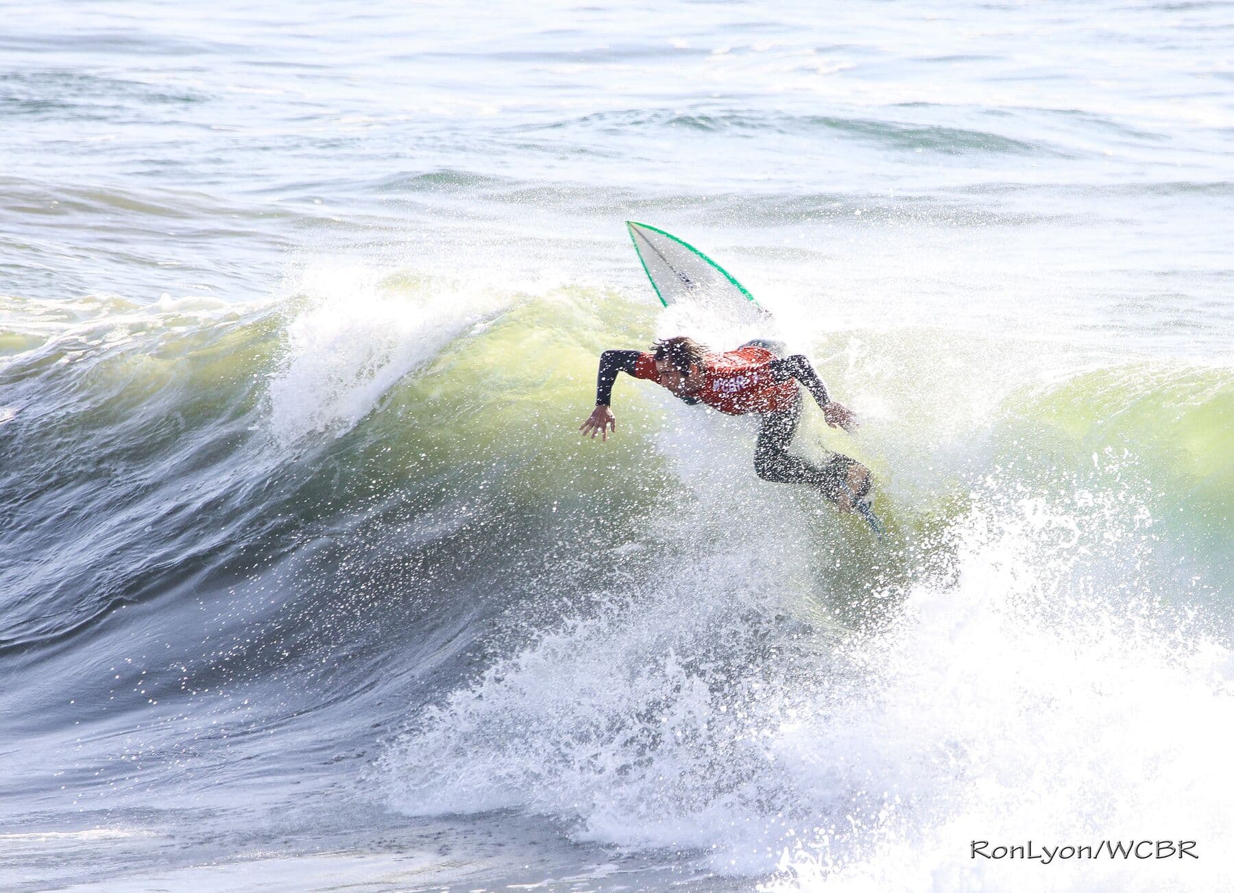 A surfer carving through whitewater