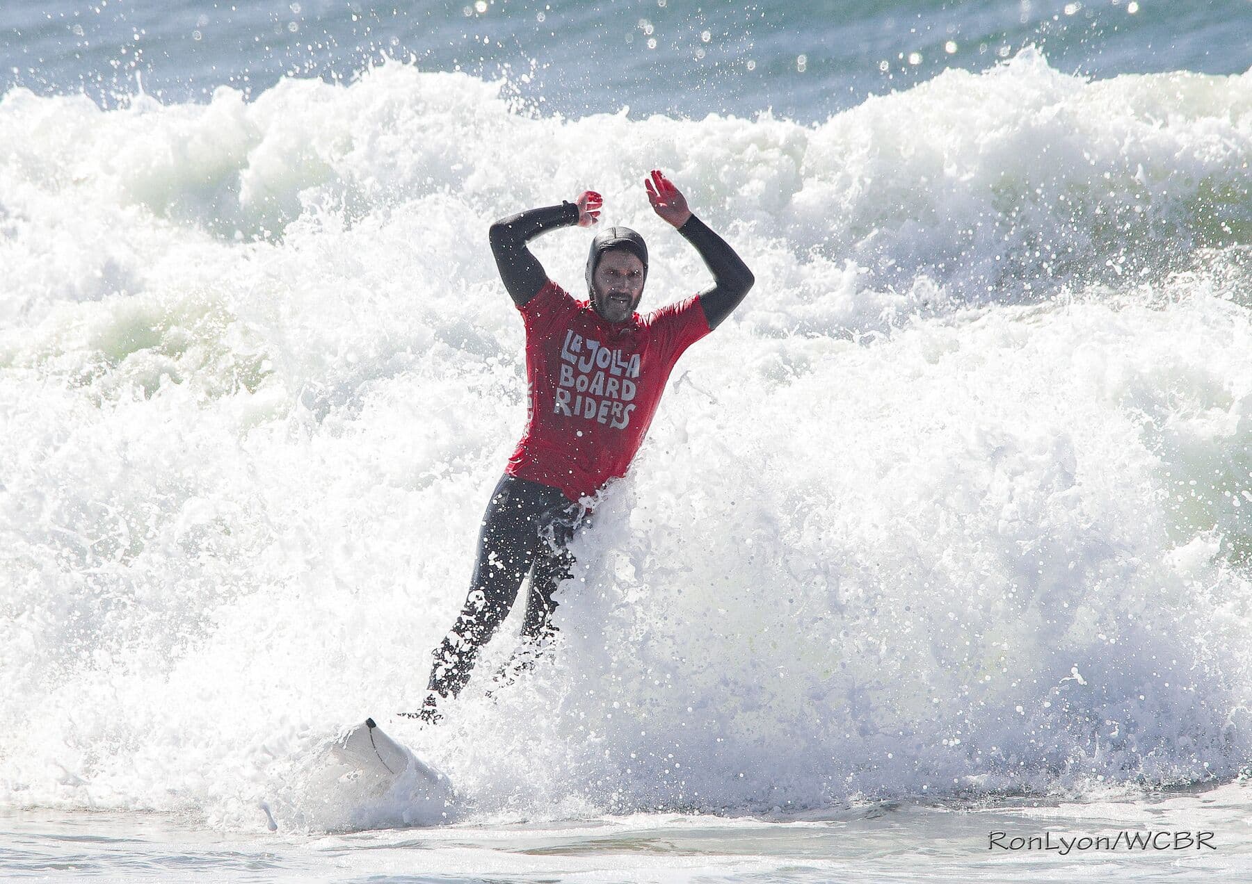 A surfer celebrating in the foam