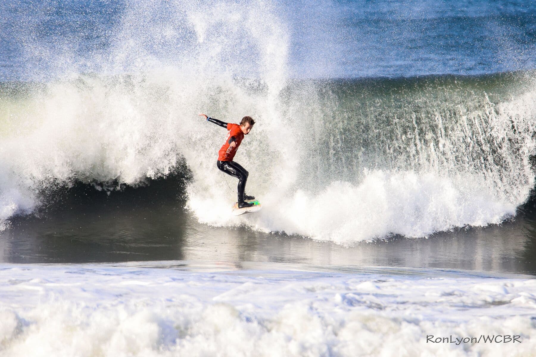 A Windansea surfer hacking the lip during a contest