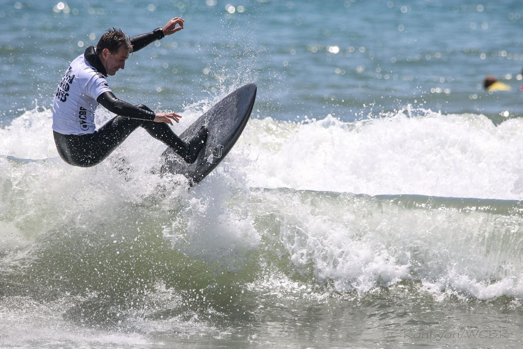 A surfer laying back into a turn