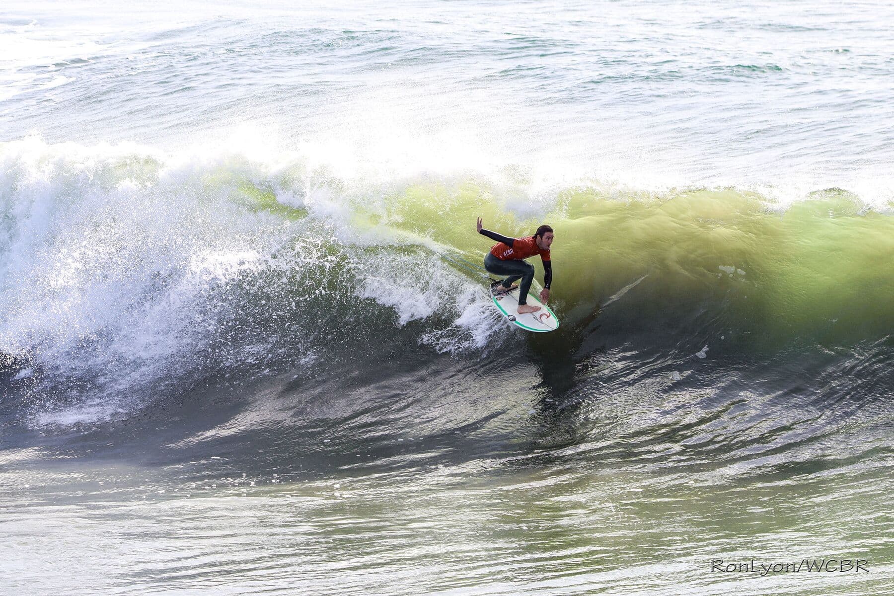 A surfer setting a line down the face