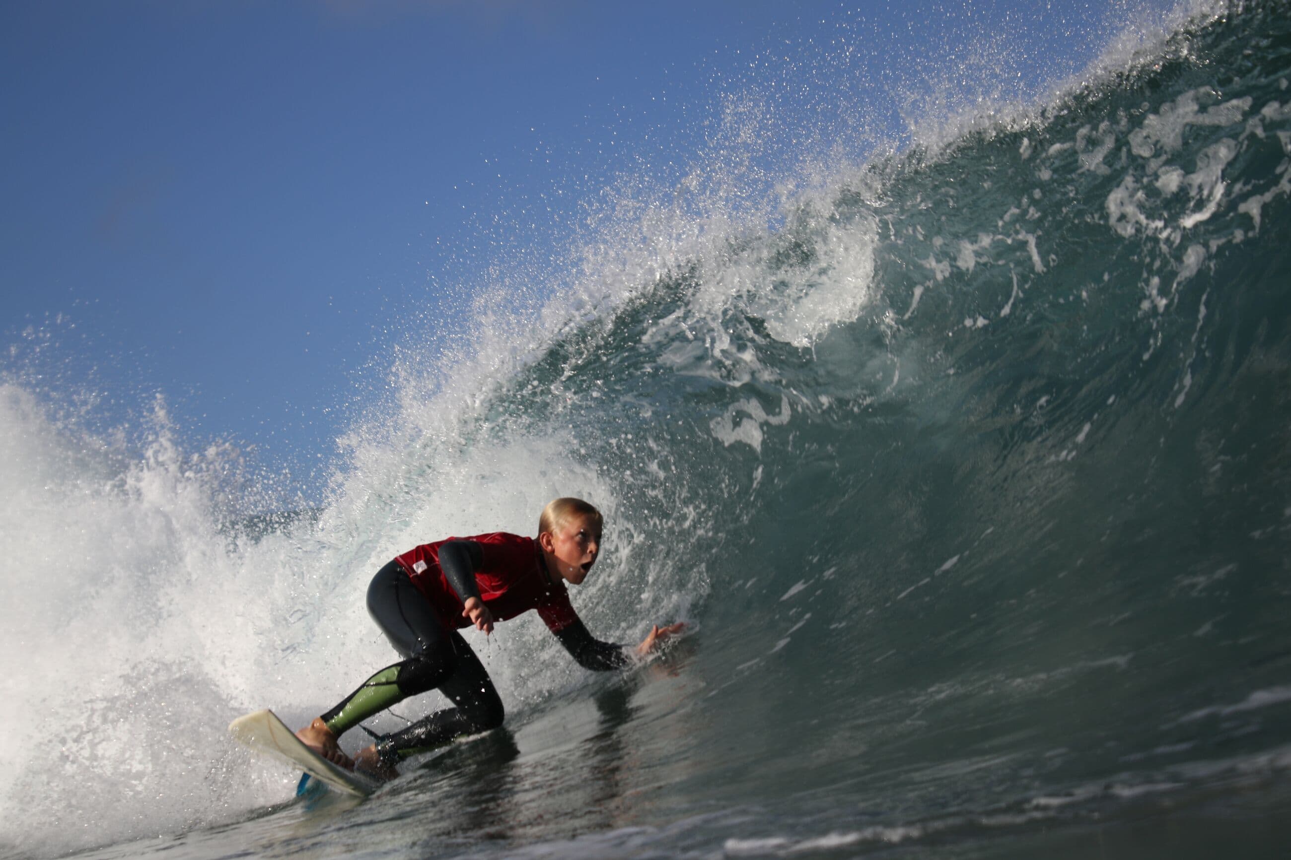 A young Windansea surfer tucking into a glassy barrel